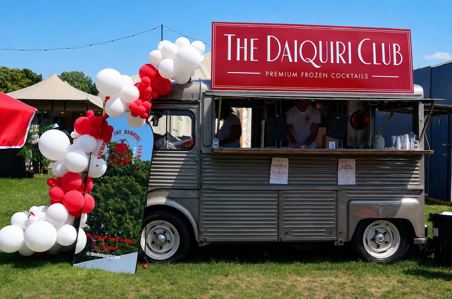 The Daiquiri Club cocktail van with red and white balloons on a sunny day