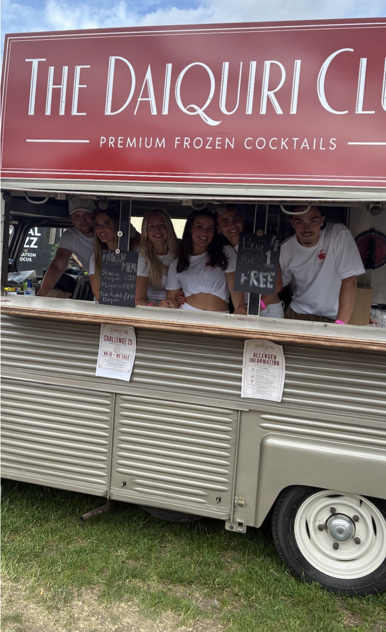 The Daiquiri Club team smiling from inside the van