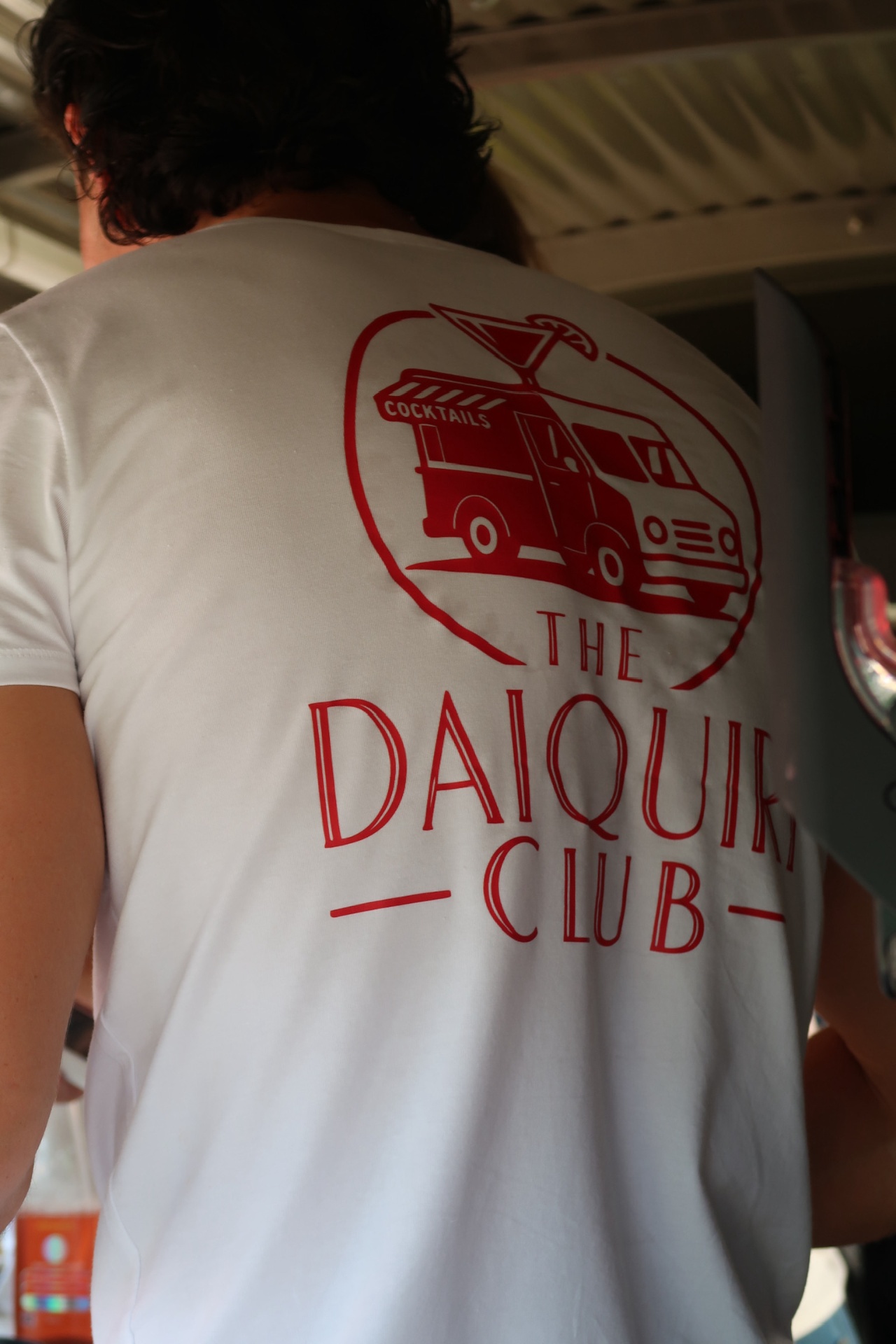 The Daiquiri Club logo on a white tee