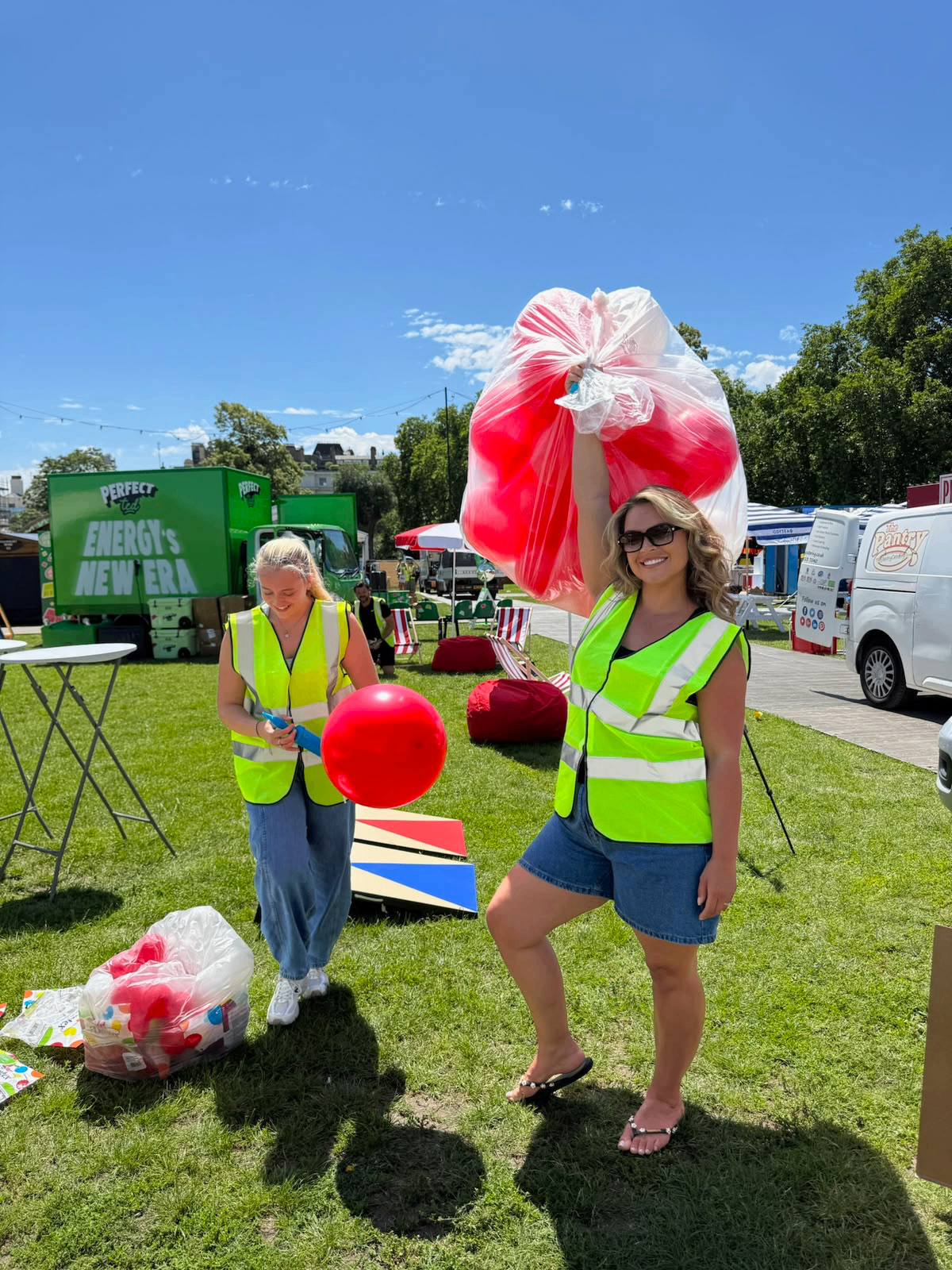 Team carrying red and white balloons on set-up day
