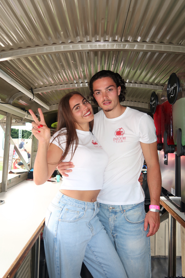 Two team members smiling inside The Daiquiri Club van